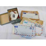 A small box and an envelope containing a collection of assorted stamps on paper, letters, etc.