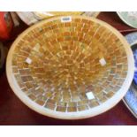 A large terracotta dish with inset glass mosaic tiled pattern