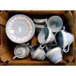 A box containing a Wedgwood part tea set in the Embossed Queensware pattern comprising cups and