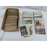 A box containing a collection of early 20th Century and other postcards including topographic,