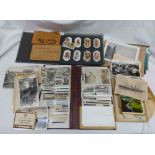 A box containing a collection of assorted cigarette cards including two albums of corner mounted
