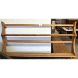 A 96cm Ercol light elm wall mounted two shelf open plate rack with shaped sides