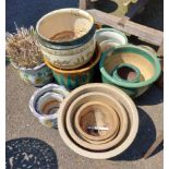 A large quantity of ceramic garden pots of varying design and finish