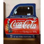 A reproduction Coca-Cola car door form wall mirror