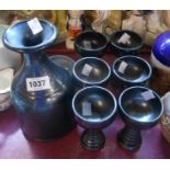 A Tintagel Pottery wine set comprising carafe and six tall goblets each with black lustre effect