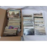 A box containing a collection of early 20th Century and other postcards including numerous local