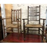 An oak framed Arts & Crafts elbow chair with pierced back rail, set on turned and tapered supports -