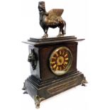 A late Victorian Middle Eastern revival black slate cased mantel clock with cast figure of the