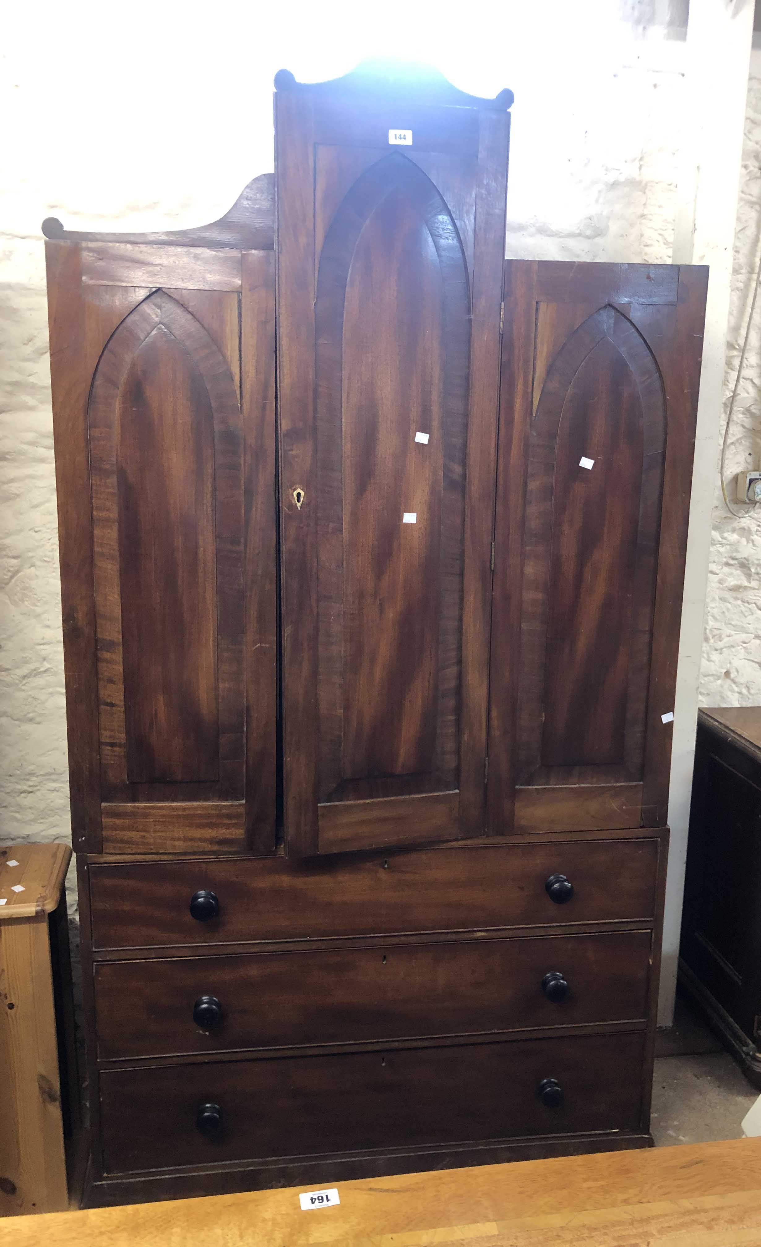 A 1.13m 19th Century mahogany Gothic style two part linen press with central mitre shaped folding