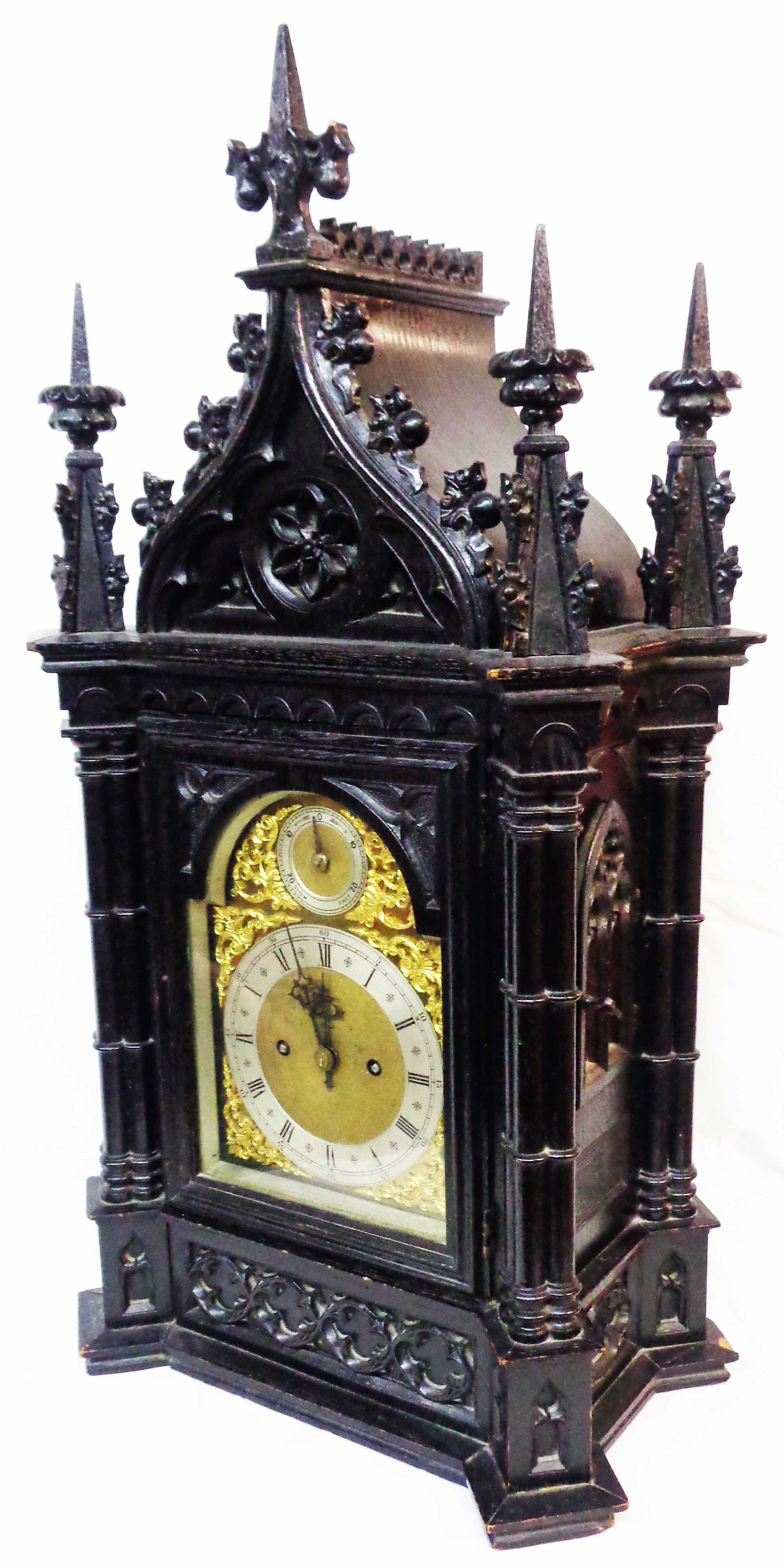 A late 19th Century Gothic Revival ornate ebonised cased table clock of architectural design with