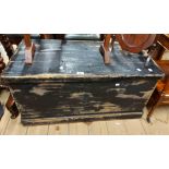An 89cm old pine lift-top box with distressed black painted finish and flanking iron drop handles
