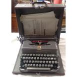 A vintage Imperial portable typewriter with gun metal grey finish in original hard carry case