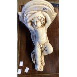 A vintage cherub pattern plaster wall shelf with cream painted finish