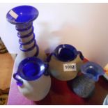 Four pieces of blue art glass with textured, sand blasted decoration and ribbon trailing
