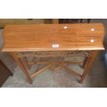 An 80cm modern Eastern hardwood side table with pierced apron and shaped stretcher