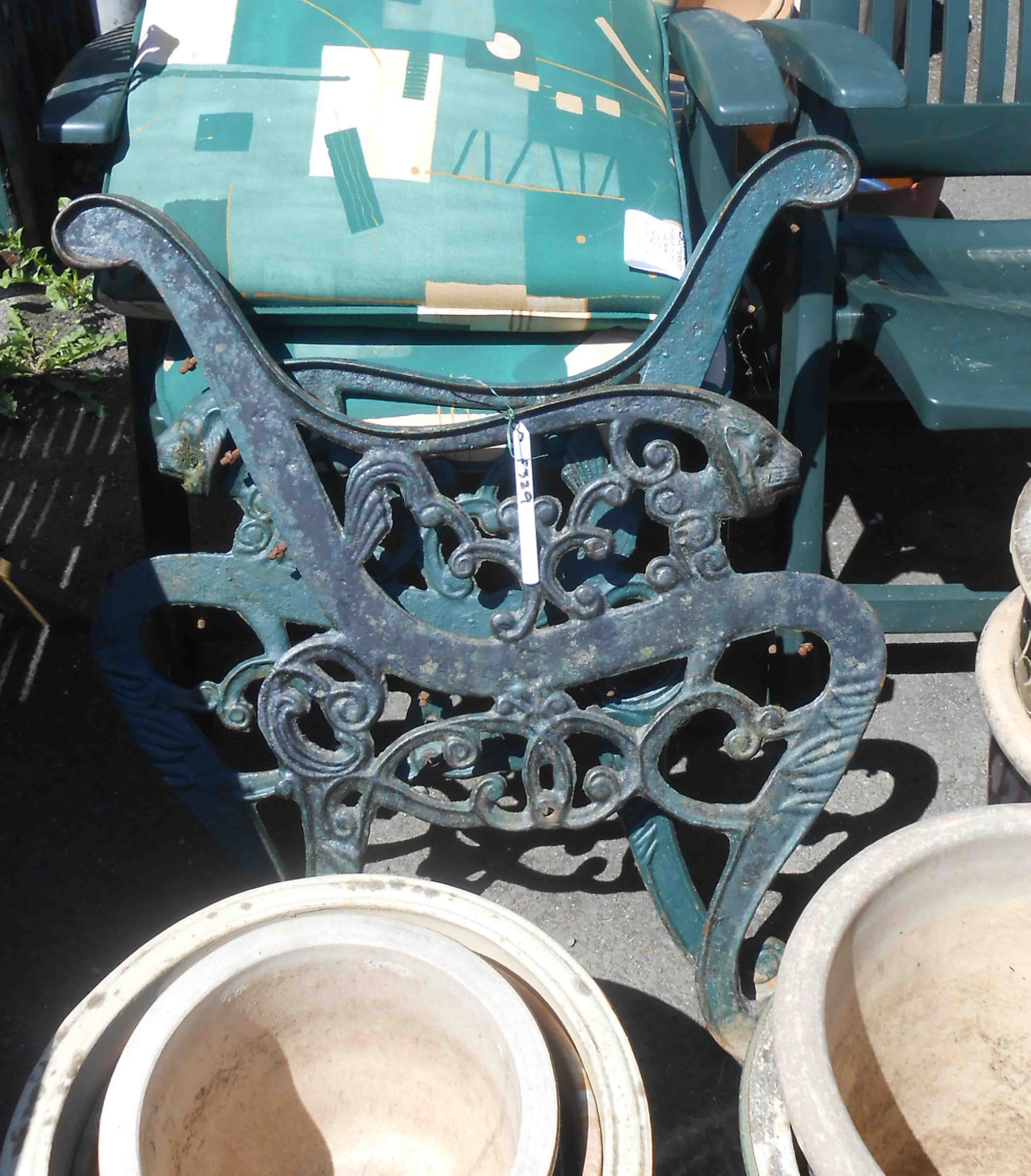 A pair of green painted cast iron bench ends