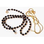 An Italian marked 14k fine-link neck chain - sold with a black onyx and yellow bead necklace