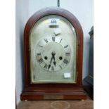 An Edwardian mahogany and strung dome cased mantel clock with silvered dial and eight day gong