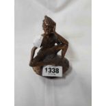 A modern cast bronze figurine depicting a pixie seated upon a toadstool