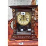 An old American shelf clock with visible mercury effect pendulum and gong striking movement