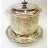 A silver plated biscuit barrel with hinged lid, engraved decoration and pierced tray base