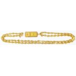 A marked 750 yellow metal anchor-link neck chain with Credit Suisse 1g ingot in marked 750 pendant