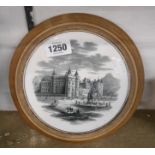 A Victorian transfer printed ceramic teapot stand with a depiction of Holyrood Palace, set in a
