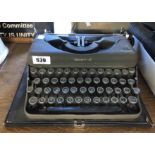 A vintage Imperial The Good Companion Model T portable typewriter with grey textured painted finish