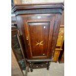 A 75cm Georgian style stained oak corner cabinet with decorative stringing and star motif to