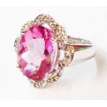 A 585 (14ct.) white gold ring, set with large central oval pink topaz within a diamond encrusted