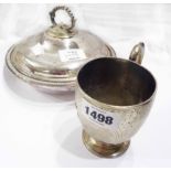 An 8.5cm high silver christening mug with cast scroll handle, ornate engraved decoration and central