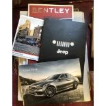 A small collection of car sales brochures including Bentley, Jeep and Mini