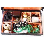 An upholstered box containing a quantity of costume and other jewelley, also a damaged verge