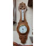 A 20th Century carved oak framed banjo barometer/thermometer with printed dial and aneroid works