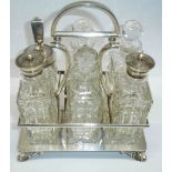 A six bottle cut glass cruet set with silver plated stand and decorative cast feet - one bottle