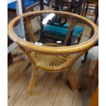 A 57cm diameter modern cane two tier occasional table with inset glass top