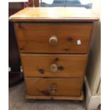A 46cm modern pine bedside chest of three drawers