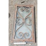 A small old wrought iron framed window with scroll beading