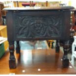 A 47cm carved oak lift-top work box in the antique style, set on turned legs - lid hinges detached -