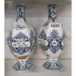 A pair of 19th Century Dutch delft vases of bottle form with pedestal foot and blue painted