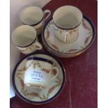 A set of four Tuscan China coffee cups and saucers with transfer-printed floral swag decoration -
