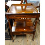 A reproduction burr walnut two tier tea trolley with slide to top and drawer to undertier, set on