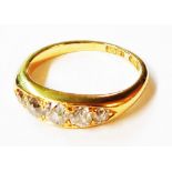 A marked 18ct. yellow metal five stone diamond ring - size M