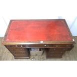 A 1.25m early 20th Century quarter sawn oak twin pedestal desk with red leather inset top, three