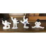 Four small modern painted cast iron Michelin Men figurines