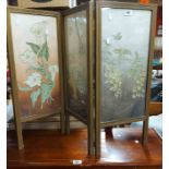 A vintage three fold low screen with floral embroidered canvas panels under glass and reeded frame