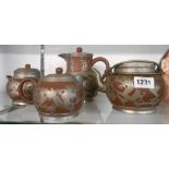 A four piece vintage Chinese Paktong pewter clad brown stoneware tea set comprising teapot, hot