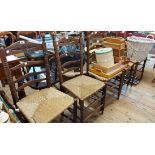 Five old Dutch stained beech framed ladder back dining chairs with woven rush seats, set on ring
