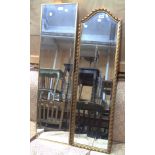Two narrow oblong bevelled wall mirrors, one with decorative gilt border and arched plate, the other