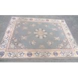 A vintage Oriental machine made wool rug with various motifs on grey ground - 2.2m X 1.7m